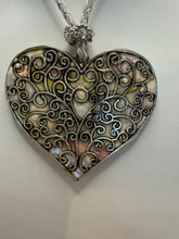 Silver filigree heart clay filled with patterned clay and on a leather braided cording necklace