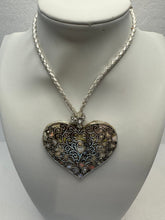 Silver filigree heart clay filled with patterned clay and on a leather braided cording necklace