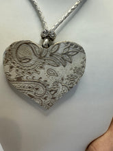 Silver filigree heart clay filled with patterned clay and on a leather braided cording necklace
