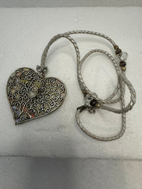Silver filigree heart clay filled with patterned clay and on a leather braided cording necklace