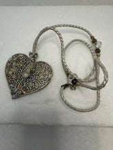 Silver filigree heart clay filled with patterned clay and on a leather braided cording necklace