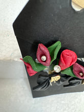 Red rose and lily handmade flower bouquet earrings secured in a black gold centered bow