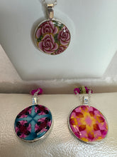 Round pendants filled with patterned polymer clay in various colors on dainty coordinated chains