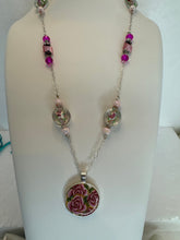 Round pendants filled with patterned polymer clay in various colors on dainty coordinated chains
