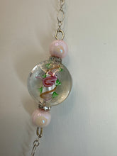 Round pendants filled with patterned polymer clay in various colors on dainty coordinated chains