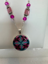 Round pendants filled with patterned polymer clay in various colors on dainty coordinated chains