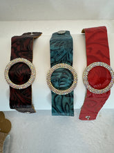 Rhinestone encrusted circle on embossed leather of different shades