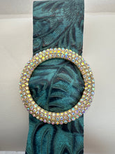 Rhinestone encrusted circle on embossed leather of different shades