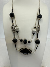 Black wire wrapped stone in a double strand necklace with silver and black beads