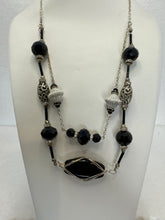 Black wire wrapped stone in a double strand necklace with silver and black beads
