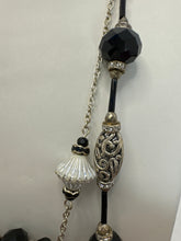 Black wire wrapped stone in a double strand necklace with silver and black beads