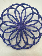 Resin hot pads in floral and swirl patterns