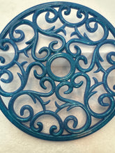 Resin hot pads in floral and swirl patterns